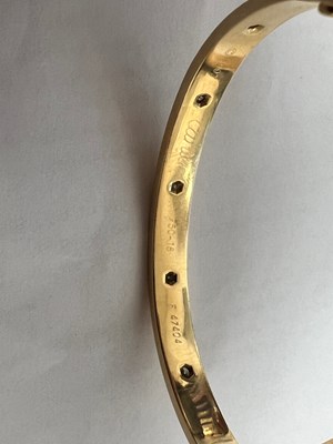 Lot 605 - A CARTIER 18 CARAT GOLD AND DIAMOND LOVE BANGLE WITH BOX AND CERTIFICATION