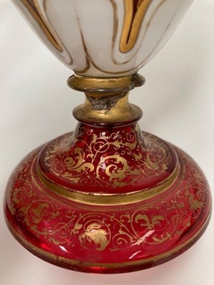 Lot 30 - A 19TH CENTURY BOHEMIAN GILDED AND PAINTED RUBY GLASS EWER AND GOBLET