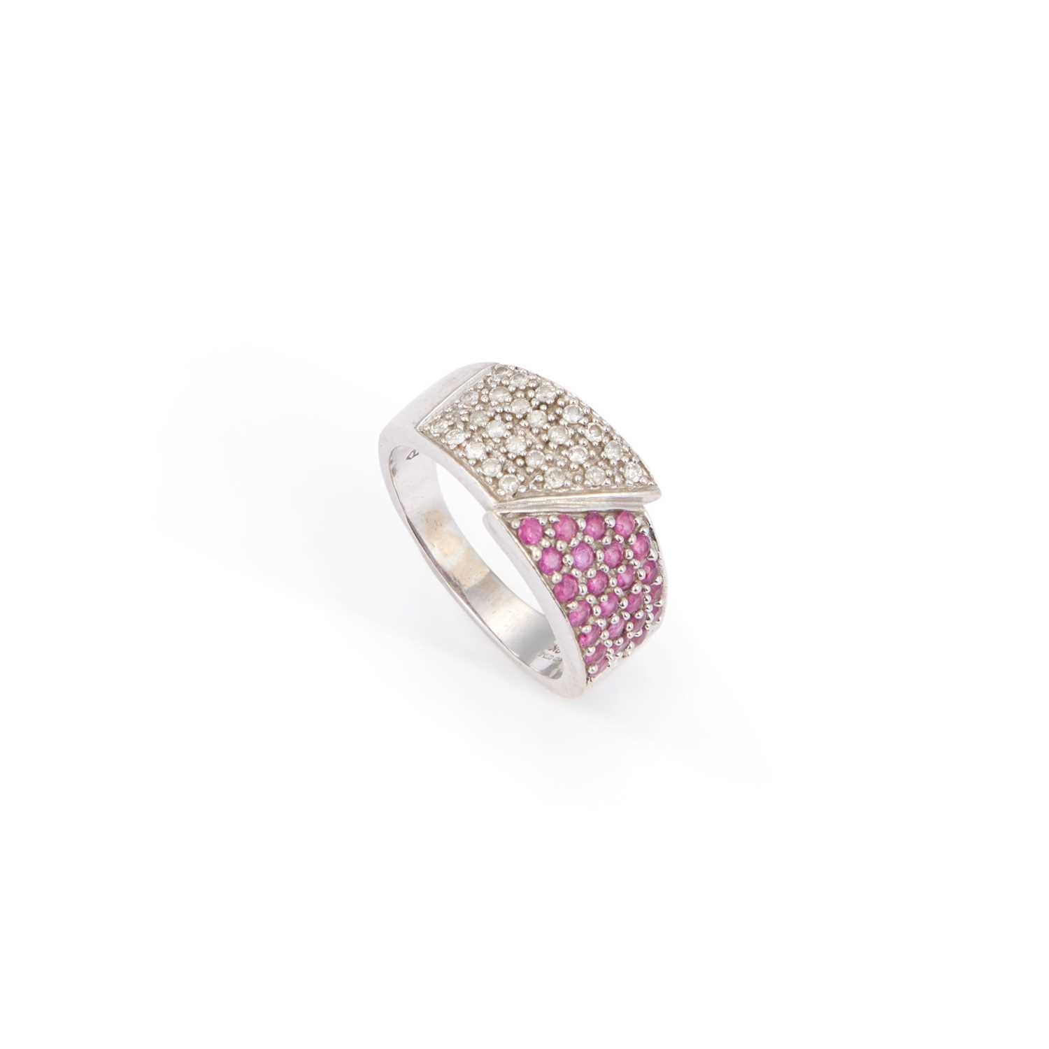 Lot A 9 CARAT WHITE GOLD RUBY AND DIAMOND CROSSOVER BAND RING