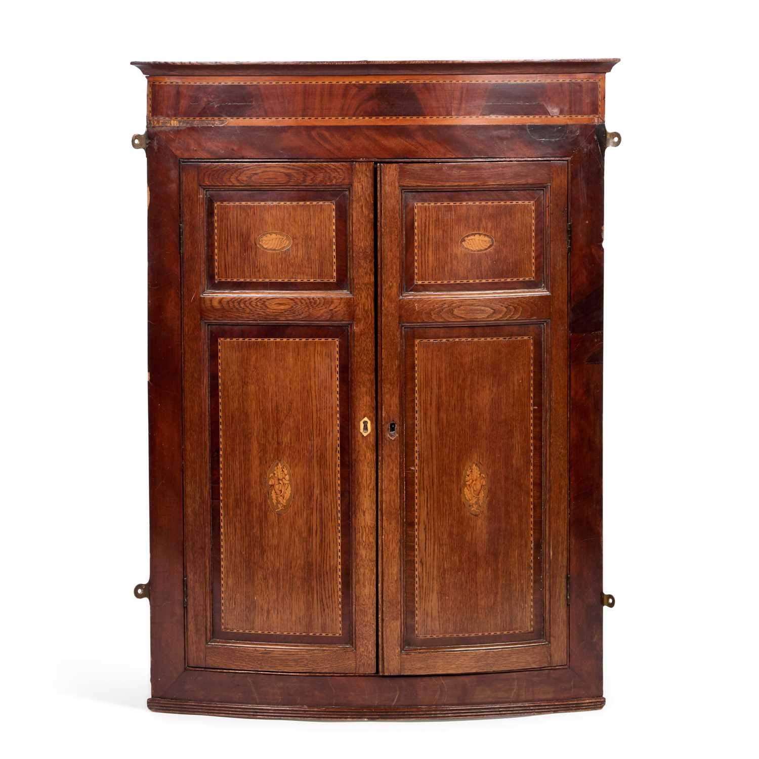 Lot A GEORGE III INLAID OAK AND MAHOGANY HANGING BOW-FRONT CORNER CUPBOARD