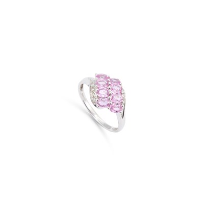 Lot 711 - A 9 CARAT WHITE GOLD PINK SAPPHIRE AND DIAMOND RING