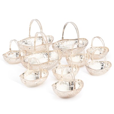 Lot 404 - A SET OF TEN ELIZABETH II SILVER SWING-HANDLE BASKETS
