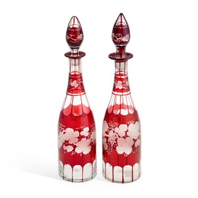 Lot 74 - A NEAR PAIR OF RUBY GLASS DECANTERS AND STOPPERS