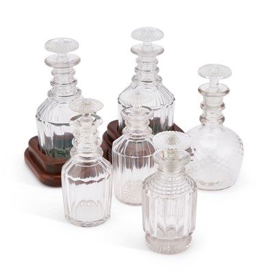 Lot 62 - A PAIR OF EARLY 19TH CENTURY GLASS DECANTERS ON WOODEN COASTERS