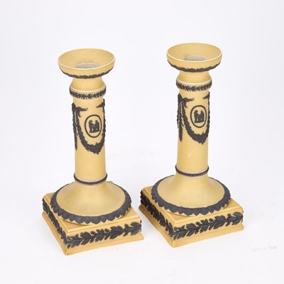 Lot A PAIR OF WEDGWOOD YELLOW GROUND CANDLESTICKS, C.1900